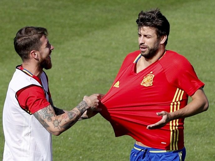 Spain's players Sergio Ramos (L) and Gerard Pique (R) joke during the team's training session held in Re Island, France, 24 June 2016. Spain will face Italy the next 27 June in a quarter final soccer match of the Euro 2016 in Paris, France.