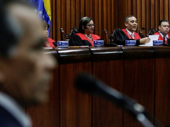 Venezuela's Supreme Court President Maikel Moreno (2nd R) talks to the media during a news conference, next to Venezuela's Supreme Court First Vice President Indira Alfonzo (3rd R) and Venezuela's Supreme Court Second Vice President Juan Mendoza (R), in Caracas, Venezuela March 27, 2017. REUTERS/Marco Bello