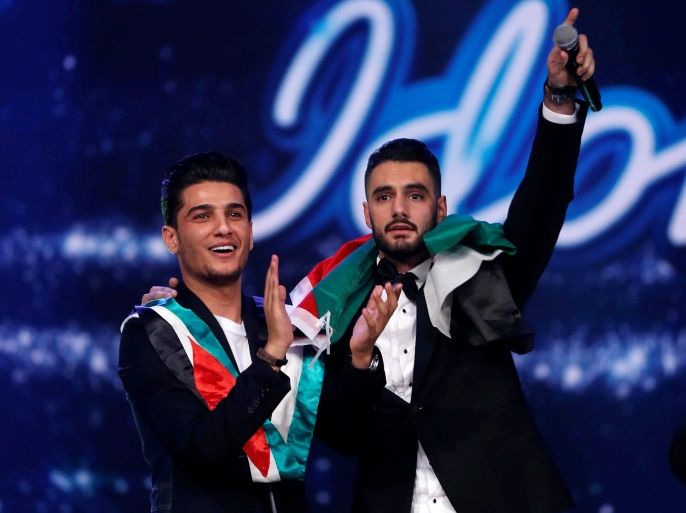 Palestinian singer Yaqoub Shaheen (R), winner of Arab Idol season 4, gestures as he stands next to Palestinian singer Mohammed Assaf, winner of the second season of Arab Idol, during the final episode of Arab Idol season 4, in Zouk Mosbeh area, north of Beirut, Lebanon February 25, 2017. REUTERS/Mohamed Azakir