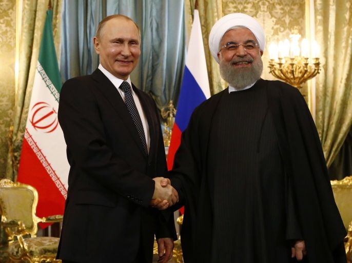 Russian President Vladimir Putin shakes hands with Iranian President Hassan Rouhani during their meeting at the Kremlin in Moscow, Russia March 28, 2017. REUTERS/Sergei Karpukhin