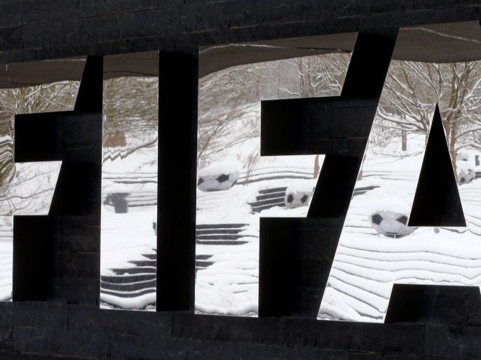 The snow-covered landscape is reflected in a logo in front of FIFA headquarters in Zurich, Switzerland, January 10, 2017. REUTERS/Arnd Wiegmann