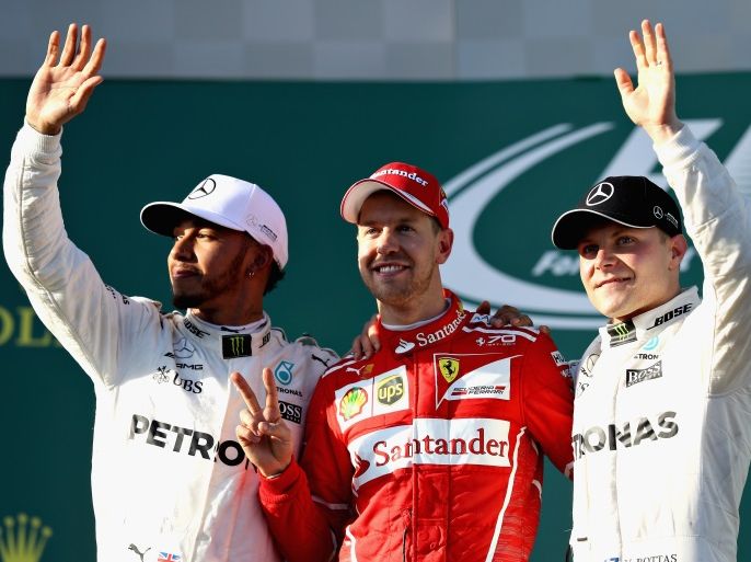 MELBOURNE, AUSTRALIA - MARCH 26: Sebastian Vettel of Germany and Ferrari celebrates his win on the podium with second placed Lewis Hamilton of Great Britain and Mercedes GP and Valtteri Bottas of Finland and Mercedes GP during the Australian Formula One Grand Prix at Albert Park on March 26, 2017 in Melbourne, Australia. (Photo by Mark Thompson/Getty Images)
