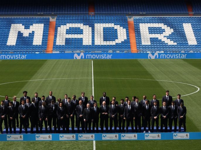 Real Madrid's president Florentino Perez and Telefonica's chairman and CEO Jose Maria Alvarez-Pallete pose with Real Madrid's soccer and basketball teams during an event to announce an agreement with Telefonica as Real Madrid's new sponsor at Santiago Bernabeu stadium in Madrid, Spain, March 30, 2017. REUTERS/Susana Vera