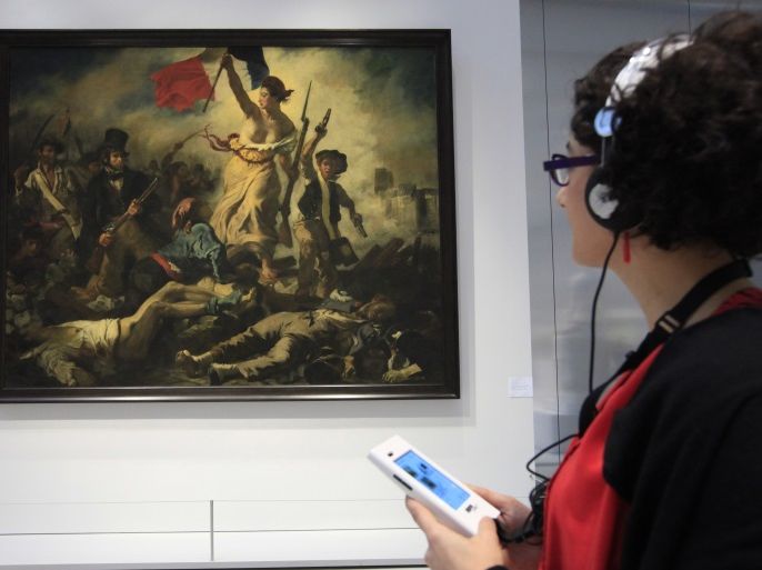 A visitor looks at Eugene Delacroix 's painting,