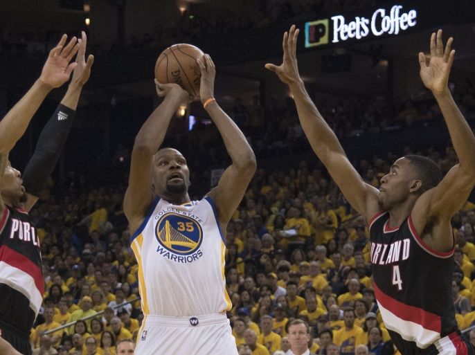 April 16, 2017; Oakland, CA, USA; Golden State Warriors forward Kevin Durant (35) shoots the basketball against Portland Trail Blazers guard Damian Lillard (0) and forward Maurice Harkless (4) during the second quarter in game one of the second round of the 2017 NBA Playoffs at Oracle Arena. Mandatory Credit: Kyle Terada-USA TODAY Sports