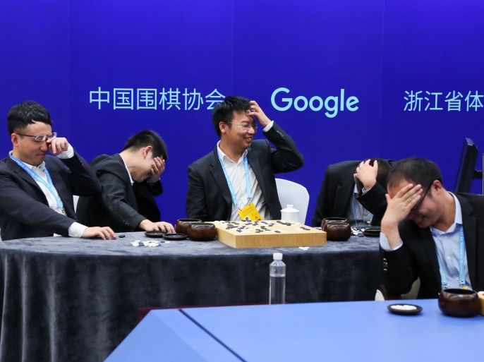 Chinese Go players Chen Yaoye, Shi Yue, Mi Yuting, Tang Weixing, and Zhou Ruiyang react during the match where they form a team of five against Google's artificial intelligence program AlphaGo, at the Future of Go Summit in Wuzhen, Zhejiang province, China May 26, 2017. Picture taken May 26, 2017. REUTERS/Stringer ATTENTION EDITORS - THIS IMAGE WAS PROVIDED BY A THIRD PARTY. EDITORIAL USE ONLY. CHINA OUT. TPX IMAGES OF THE DAY