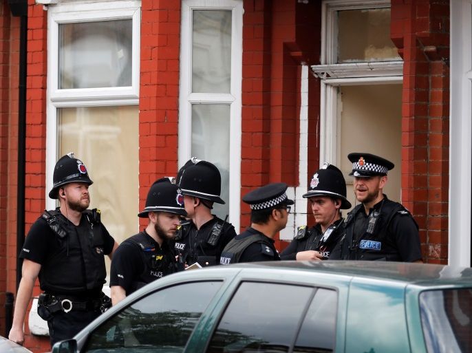 Police officers stand outside a house in Moss Side, Manchester, Britain May 27, 2017. REUTERS/Phil Noble