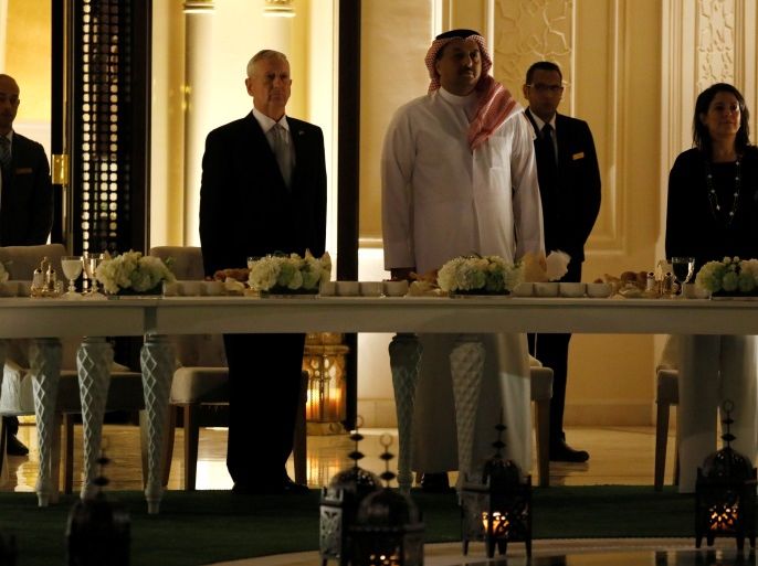 Qatar's Minister of Defense Khalid bin Mohammad Al-Attiyah (center right, in robe), U.S. Defence Secretary James Mattis (centre left, in dark suit) and U.S. Ambassador to Qatar Dana Shell Smith (R) stand for the playing of their national anthems before a dinner at the minister's residence in Doha, Qatar April 22, 2017. REUTERS/Jonathan Ernst
