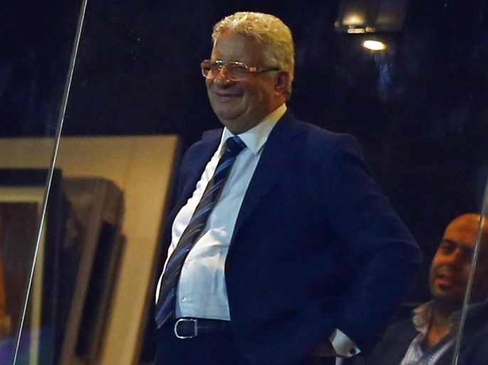 Zamalek Chairman Mortada Mansour (R) smiles in the viewing room, after his team defeated Smouha during the Egypt Cup final soccer match at Air Defence