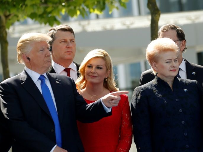 (L-R) U.S. President Donald Trump gestures next to Croatia's President Kolinda Grabar-Kitarovic, Germany's Chancellor Angela Merkel, France's President Emmanuel Macron, Belgium's Prime Minister Charles Michel and Luxembourg's Prime Minister Xavier Bettel during a NATO summit at their new headquarters in Brussels, Belgium, May 25, 2017. REUTERS/Jonathan Ernst?