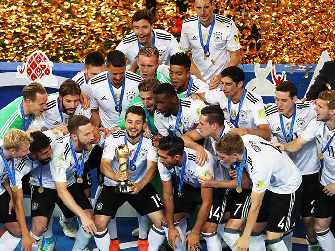 epa06062441 Amin Younes of Germany raises the trophy after Germany won the FIFA Confederations Cup 2017 final match between Chile and Germany at the Saint Petersburg stadium in St.Petersburg, Russia, 02 July 2017. Germany won 1-0. EPA/SRDJAN SUKI