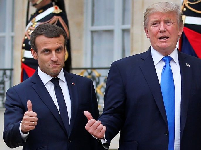 French President Emmanuel Macron and U.S. President Donald Trump react in the courtyard after a joint news conference at the Elysee Palace in Paris, France, July 13, 2017. REUTERS/Stephane Mahe TPX IMAGES OF THE DAY