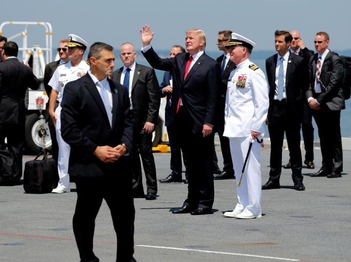 U.S. President Donald Trump (C), flanked by U.S. Navy Captain Richard McCormack (in white), departs after commissioning the aircraft carrier USS Gerald R. Ford at Naval Station Norfolk in Norfolk, Virginia, U.S. July 22, 2017. REUTERS/Jonathan Ernst