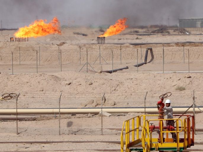 A worker adjusts a valve of an oil pipe in Zubair oilfield in Basra, Iraq July 20, 2017. REUTERS/Essam Al-Sudani
