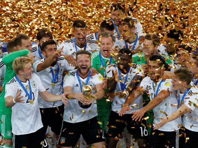 Soccer Football - Chile v Germany - FIFA Confederations Cup Russia 2017 - Final - Saint Petersburg Stadium, St. Petersburg, Russia - July 2, 2017 Germany’s Shkodran Mustafi celebrates with the trophy and team mates after winning the FIFA Confederations Cup REUTERS/Maxim Shemetov
