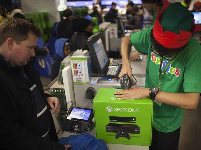 A man buys an XBOX One video game console at a Toys