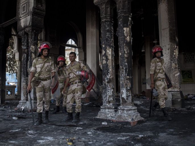CAIRO, EGYPT - AUGUST 15: Egyptian Military Police soldiers stand guard inside the burnt-out Rabaa al-Adaweya Mosque in Nasr City on August 15, 2013 in Cairo, Egypt. An unknown number of pro-Morsi protesters were killed in Egypt's capital yesterday as Egyptian Security Forces undertook a planned operation to clear Morsi supporters from two sit-in demonstrations in Cairo where they have camped for over one month. Egyptian Police and Army forces entered protest sites in the Nasr City and Giza districts at dawn on August 14, using tear gas, live fire and bulldozers to disperse protesters and destroy the camps. A state of emergency has been declared in Egypt that began yesterday afternoon and will last for one month. (Photo by Ed Giles/Getty Images)