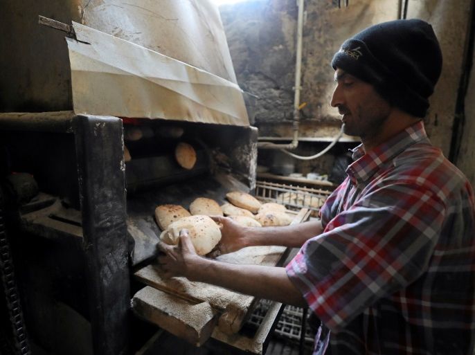 A baker collects bread at a bakery in Cairo, Egypt March 9, 2017. Picture taken March 9, 2017. REUTERS/Mohamed Abd El Ghany