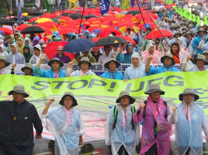South Korean protesters hold a banner reading 'Stop! UFG (Ulchi-Freedom Guardian joint military exercise)' as they march towards the US embassy during an anti-US rally demanding peace in the Korean Peninsula in Seoul on August 15, 2017.North Korean leader Kim Jong-Un said on August 15 he would hold off on a planned missile strike near Guam, but warned the highly provocative move would go ahead in the event of further 'reckless actions' by Washington. / AFP PHOTO / JUNG Yeon-Je (Photo credit should read JUNG YEON-JE/AFP/Getty Images)