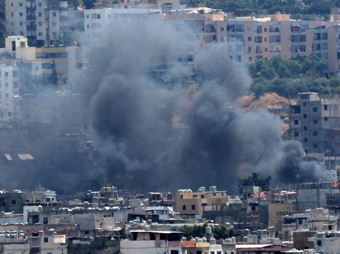 Smoke rises from buildings in Ain el-Helweh, Lebanon's largest Palestinian refugee camp, near the southern coastal city of Sidon, during ongoing clashes between Palestinian security forces and Islamist fighters on August 21, 2017.The clashes first broke out on August 17 when gunmen from the small Islamist Badr group opened fire on a position of Palestinian security forces inside the camp, a Palestinian source said. / AFP PHOTO / Mahmoud ZAYYAT (Photo credit should read MAHMOUD ZAYYAT/AFP/Getty Images)