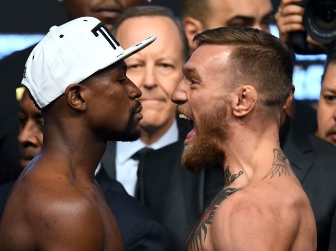 LAS VEGAS, NV - AUGUST 25: Boxer Floyd Mayweather Jr. (L) and UFC lightweight champion Conor McGregor face off during their official weigh-in at T-Mobile Arena on August 25, 2017 in Las Vegas, Nevada. The two will meet in a super welterweight boxing match at T-Mobile Arena on August 26. (Photo by Ethan Miller/Getty Images)