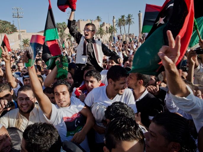 TRIPOLI, LIBYA - AUGUST 31: People celebrate as they gather at Martyr Square formerly known as Green Square, for the Eid Al-Fitr prayer on August 31, 2011 in Tripoli, Libya. Libyans celebrated the first Eid Al-Fitr in 42 years under a new regime. (Photo by Daniel Berehulak/Getty Images)