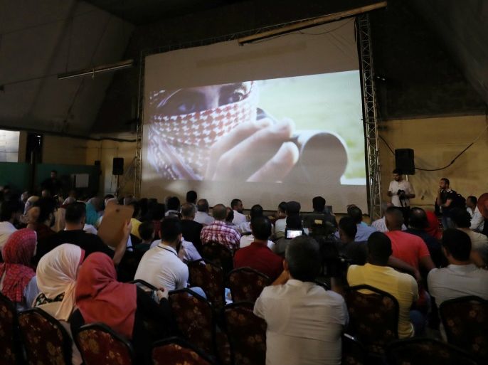 Palestinians watch the film