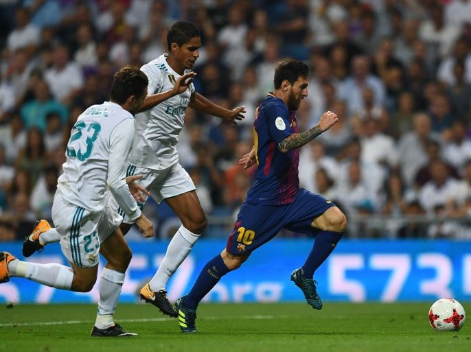 Barcelona's Argentinian forward Lionel Messi (R) vies with Real Madrid's French defender Raphael Varane (C) during the second leg of the Spanish Supercup football match Real Madrid vs FC Barcelona at the Santiago Bernabeu stadium in Madrid, on August 16, 2017. / AFP PHOTO / GABRIEL BOUYS (Photo credit should read GABRIEL BOUYS/AFP/Getty Images)