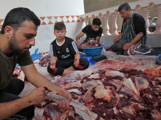Palestinian men divide meat after slaughtering a bull at a residence in Rafah in the southern Gaza Strip, on September 1, 2017, as part of the commemoration for the first day of Eid al-Adha.Eid al-Adha (the Festival of Sacrifice) is celebrated throughout the Muslim world as a commemoration of Abraham's willingness to sacrifice his son for God, and cows, camels, goats and sheep are traditionally slaughtered on the holiest day. / AFP PHOTO / SAID KHATIB (Photo credit should read SAID KHATIB/AFP/Getty Images)