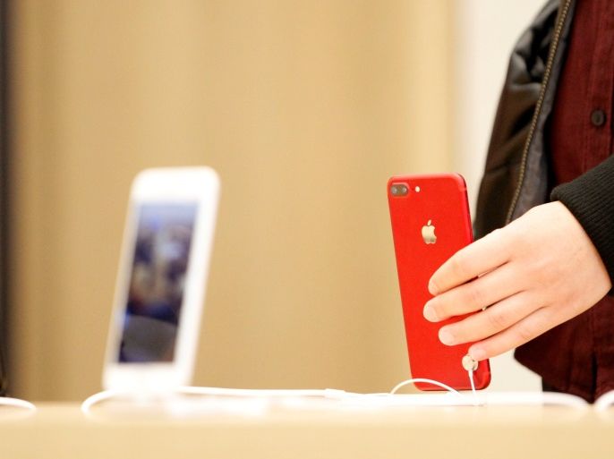 A person holds a red iPhone product at a Apple store in Nanjing, Jiangsu province, China, March 25, 2017. Picture taken March 25, 2017. REUTERS/Stringer ATTENTION EDITORS - THIS IMAGE WAS PROVIDED BY A THIRD PARTY. EDITORIAL USE ONLY. CHINA OUT. NO COMMERCIAL OR EDITORIAL SALES IN CHINA.