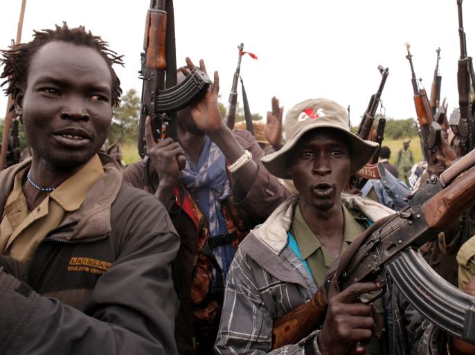 SPLA-IO (SPLA-In Opposition) rebels hold up guns in Yondu, the day before an assault on government SPLA (Sudan People's Liberation Army) soldiers in the town of Kaya, on the border with Uganda, South Sudan, August 25, 2017. REUTERS/Goran Tomasevic