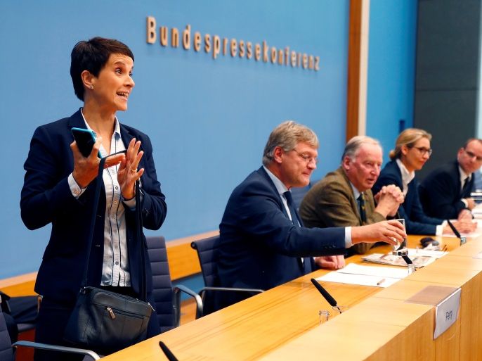 Frauke Petry, chairwoman of the anti-immigration party Alternative fuer Deutschland (AfD) leaves a news conference next to Joerg Meuthen (2nd L), leader of the party and top candidates Alice Weidel (2nd R) and Alexander Gauland in Berlin, Germany, September 25, 2017. REUTERS/Fabrizio Bensch TPX IMAGES OF THE DAY