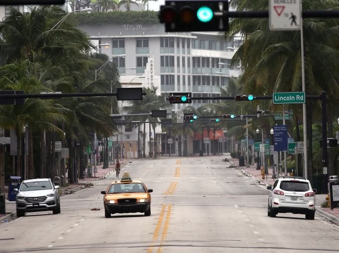 A taxi drives along an empty street in South Beach prior to the arrival of Hurricane Irma to south Florida, in Miami, Florida, U.S., September 9, 2017. REUTERS/Carlos Barria