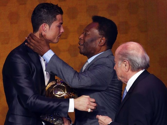 Portugal's Cristiano Ronaldo is congratulated by Pele as FIFA President Sepp Blatter (R) looks on after being awarded the FIFA Ballon d'Or 2013 in Zurich January 13, 2014. Portugal and Real Madrid forward Cristiano Ronaldo was named the world's best footballer for the second time on Monday, preventing his great rival Lionel Messi from winning the award for a fifth year in a row. REUTERS/Arnd Wiegmann (SWITZERLAND - Tags: SPORT SOCCER)