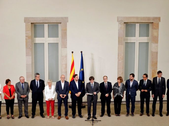 President of the Catalan Government Carles Puigdemont (C), standing in front of Catalan government's members makes an institutional declaration after signing a decree calling independence referendum at the Catalan Parliament in Barcelona, on September 6, 2017.Catalonia's parliament passed a law on September 6, 2017 paving the way for an independence referendum on October 1 which is fiercely opposed by Madrid, setting a course for Spain's deepest political crises in decades. The law was adopted with 72 votes in favour and 11 abstentions. Lawmakers who oppose independence for the wealthy northeastern region of Spain abandoned the chamber before the vote. / AFP PHOTO / Pau Barrena (Photo credit should read PAU BARRENA/AFP/Getty Images)