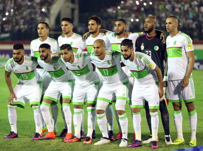 epa05578888 Algerian national soccer team players line up before the FIFA World Cup 2018 qualifying soccer match between Algeria and Cameroon at the Mustapha Tchaker Stadium in Blida south of Algiers, Algeria, 09 October 2016. EPA/STR