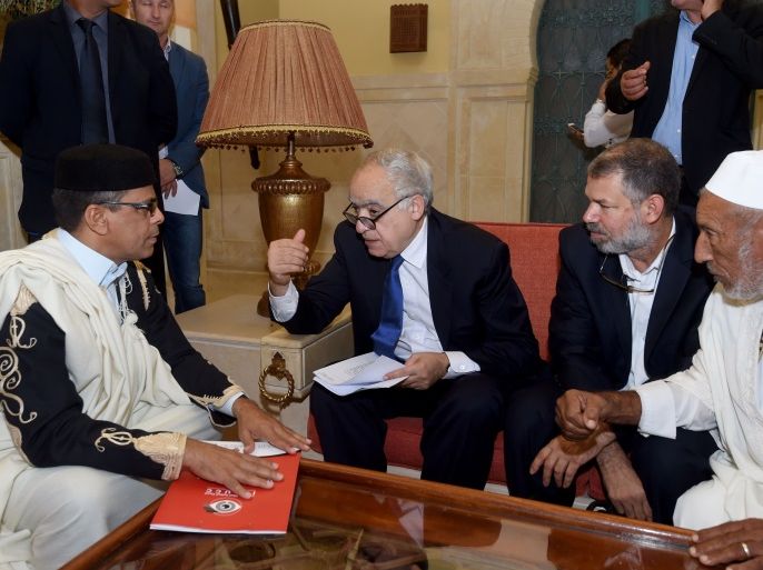 Ghassan Salame (C), special representative to the Secretary General of the United Nations for Libya, talks to the president of the supreme council of reconciliation, Mohamed Allouch (L), during a meeting with rival Libyan factions in the Tunisian capital Tunis on September 26, 2017. Neighboring Tunisia offered to act as a mediator between rival Libyan factions. Libya, which plunged into chaos after the ouster and killing of dictator Moamer Kadhafi in 2011, has two rival
