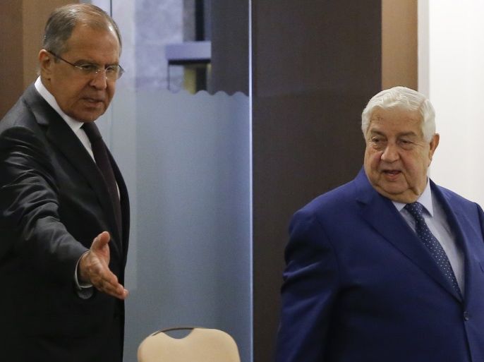 Russian Foreign Minister Sergei Lavrov (L) shows the way to his Syrian counterpart Walid al-Moualem during a meeting in Sochi, Russia October 11, 2017. REUTERS/Maxim Shemetov