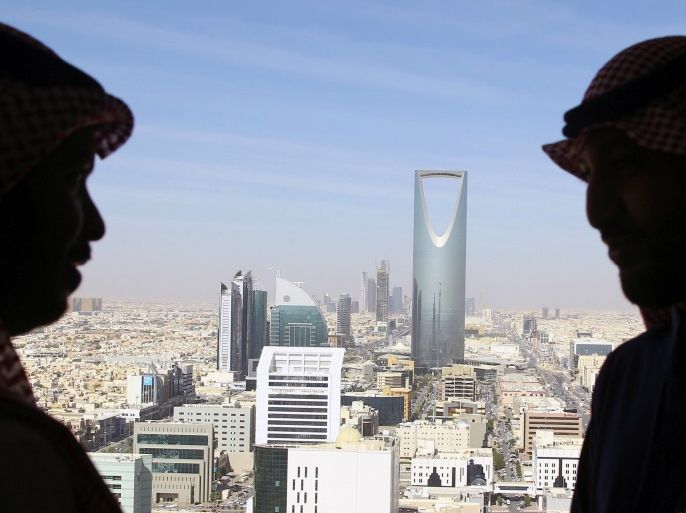 Men look out of a building as the Kingdom Centre Tower is seen in Riyadh, Saudi Arabia, January 1, 2017. REUTERS/Faisal Al Nasser