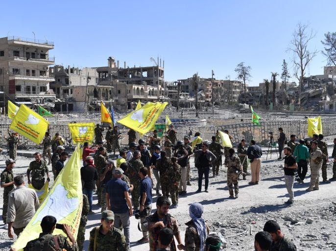 Members of the Syrian Democratic Forces (SDF), backed by US special forces, gather at the iconic Al-Naim square in Raqa on October 17, 2017.US-backed forces said they had taken full control of Raqa from the Islamic State group, defeating the last jihadist holdouts in the de facto Syrian capital of their now-shattered 'caliphate'. / AFP PHOTO / BULENT KILIC (Photo credit should read BULENT KILIC/AFP/Getty Images)