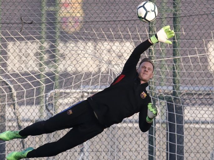 Barcelona's German goalkeeper Marc-Andre Ter Stegen dives for a ball during a training session at the Joan Gamper Sports Center in Sant Joan Despi, near Barcelona on October 13, 2017, on the eve of a Spanish League football match against Club Atletico de Madrid. / AFP PHOTO / PAU BARRENA (Photo credit should read PAU BARRENA/AFP/Getty Images)