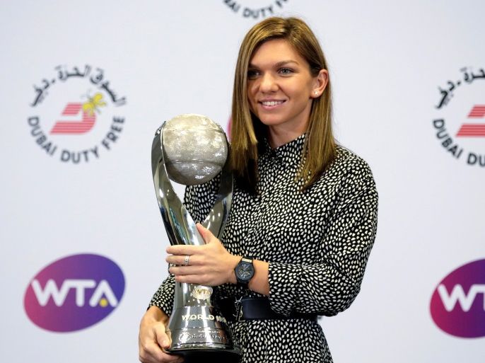 Tennis - WTA Tour Finals - Singapore Indoor Stadium, Singapore - October 29, 2017 Simona Halep of Romania poses with her WTA Year-End World Number One trophy during a news conference. REUTERS/Jeremy Lee