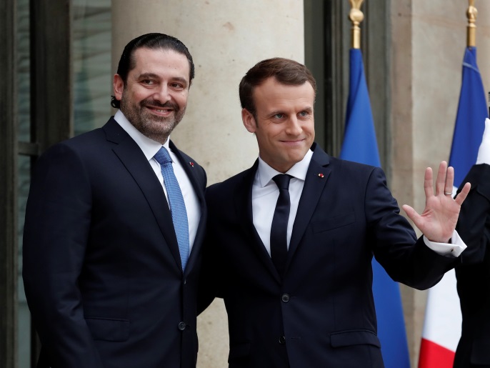 French President Emmanuel Macron and Saad al-Hariri, who announced his resignation as Lebanon's prime minister while on a visit to Saudi Arabia, react on the steps of the Elysee Palace in Paris, France, November 18, 2017. REUTERS/Benoit Tessier