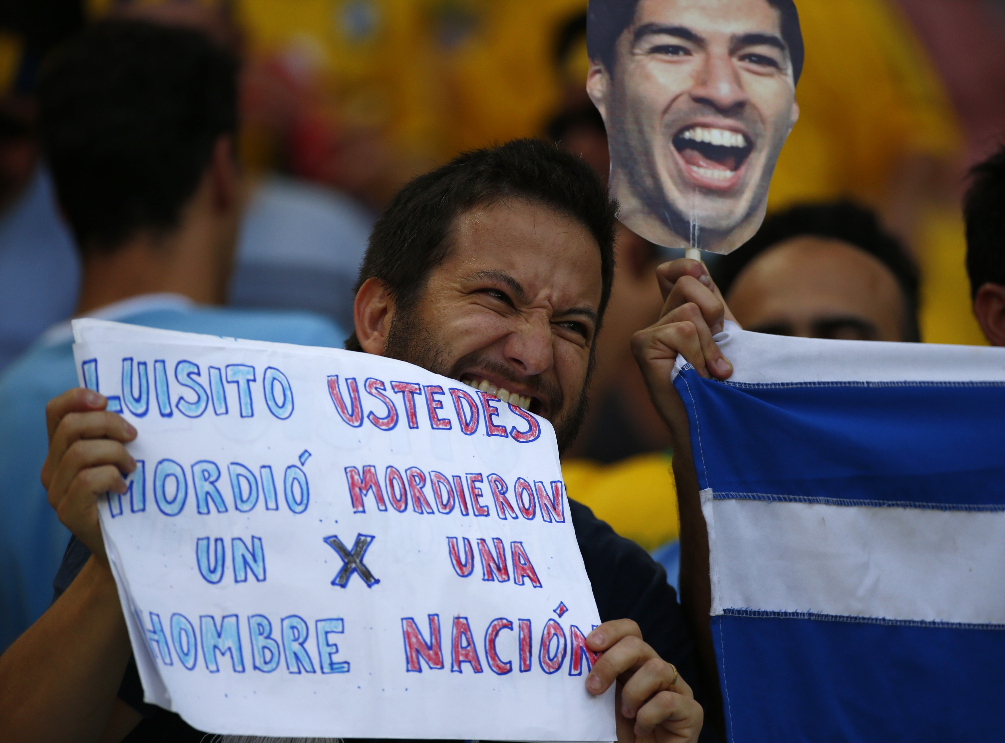 أحد مشجعي منتخب الأورغواي يرفع لافتة مكتوب عليها 