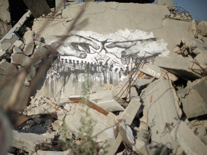 GAZA CITY, GAZA - JUNE 10: Graffiti adorns mounds of rubble bombed buildings continue to scar the landscape of Gaza on June 10, 2015, Gaza City, Gaza. The devastation across Gaza can still be seen nearly one year on from the 2014 conflict between Israel and Palestinian militants. United Nations official figures said that the 50 day war left at least 2,189 Palestinians dead, including more than 1,486 civilians, and 11,000 injured. 67 Israeli soldiers and six civilians were killed. Money pledged by the international community six months ago to rebuild Gaza has not materialised leaving many Palestinians impoverished and still suffering. (Photo by Christopher Furlong/Getty Images)