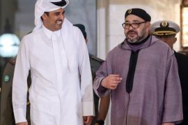 King of Morocco Mohammed VI (R) is welcomed by Emir of Qatar Sheikh Tamim bin Hamad Al Thani