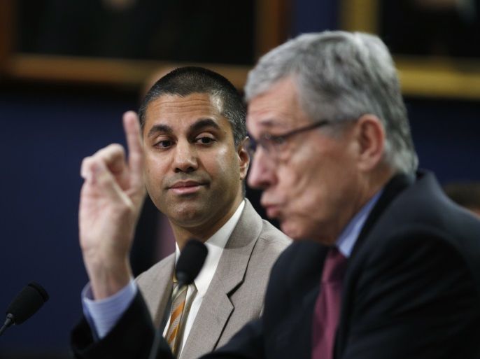 Federal Communications Commission (FCC) Commissioner Ajit Pai (L) listens as FCC Chairman Tom Wheeler testifies at a House Appropriations Financial Services and General Government Subcommittee hearing on the FCC's FY2016 budget, on Capitol Hill in Washington March 24, 2015. U.S. broadband providers on Monday filed lawsuits against the Federal Communications Commission's recently approved net neutrality rules, launching what is a expected to be a series of legal challe