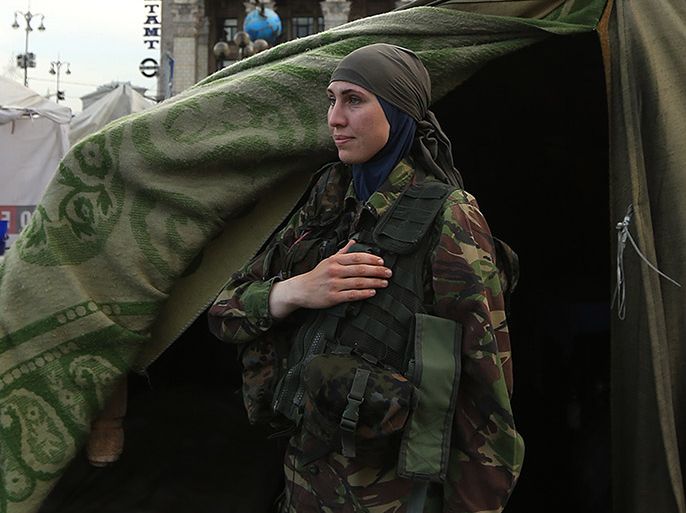 Amina Okueva, a surgeon from Chechnya, stands for the Ukrainian national anthem in Maidan Square, Kiev, Ukraine, May 18, 2014. Okueva has been living in the Ukraine for the past ten years, volunteering her services to the nationalist movement. Ukrainian nationalists moved into Maidan Square in November 2013 to protest against their pro-Russian president. Since then, they have been the victims of ongoing police brutality. (Photo by Kate Geraghty/The Sydney Morning Herald/Fairfax Media via Getty