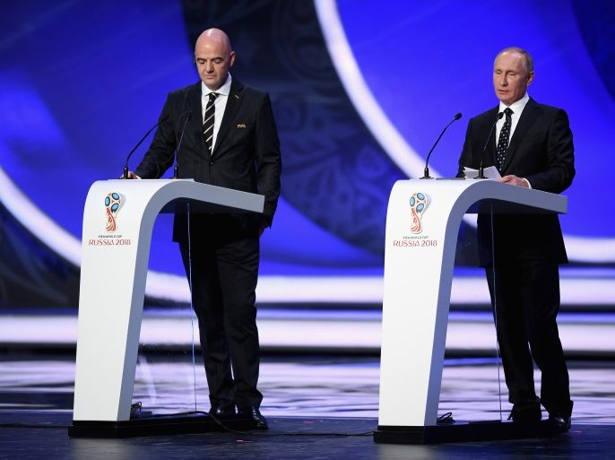 MOSCOW, RUSSIA - DECEMBER 01: FIFA President, Gianni Infantino (L) and Vladimir Putin President of Russia (R) speaks to the crowd during the Final Draw for the 2018 FIFA World Cup Russia at the State Kremlin Palace on December 1, 2017 in Moscow, Russia. (Photo by Shaun Botterill/Getty Images)