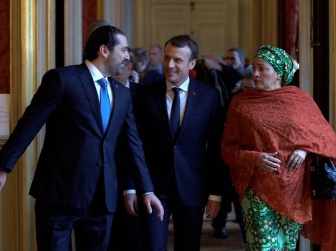 French President Emmanuel Macron walks between Lebanon's Prime Minister Saad al-Hariri and UN Deputy Secretary General Amina Mohammed as they arrive to attend the Lebanon International Support Group